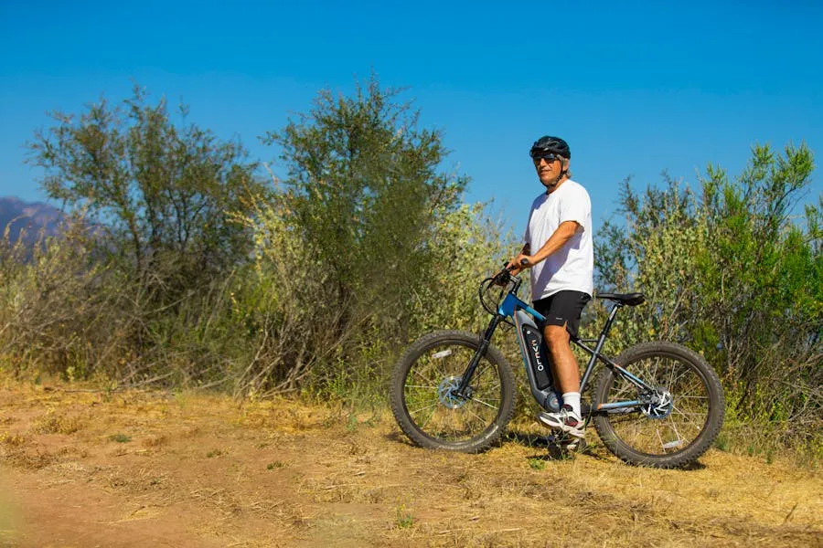 Person riding an electric bike on a wooded trail